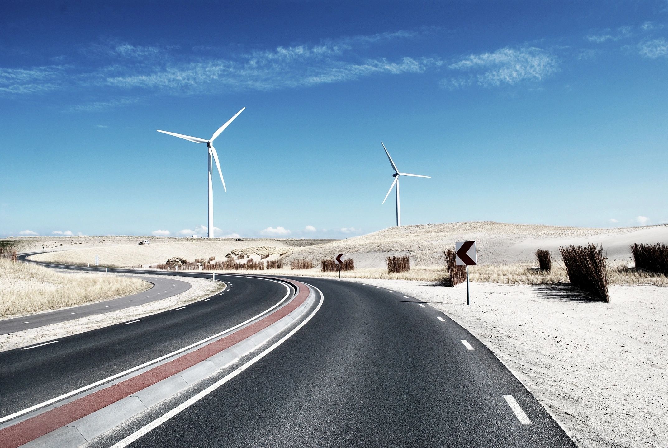 A Highway With Two Wind Mills At Some Places